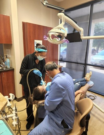 Dentist providing care to patients at the dental office